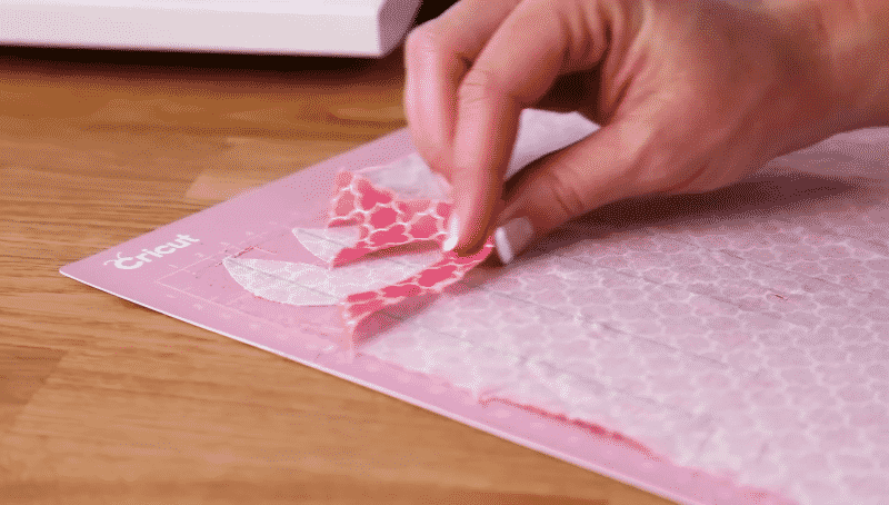 Pulling off excessive material from your pink Cricut mat