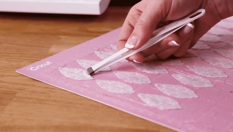 Use Broad-tipped tweezers to remove your material from the pink cutting mat