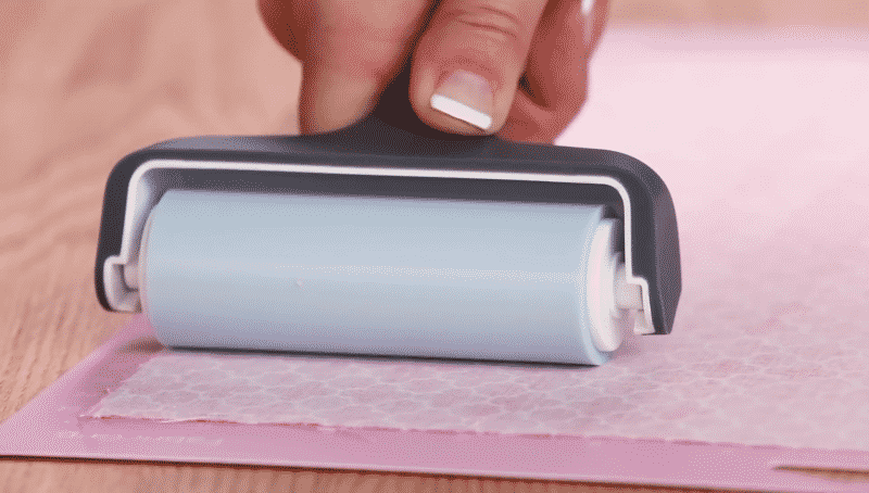 Use a Cricut brayer to smooth your fabric