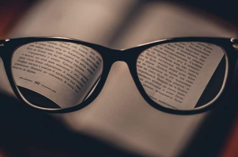 A pair of black-framed glasses puts the fine print in focus