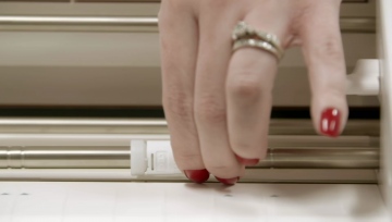 a woman slides the white pinch rollers on the roller bar