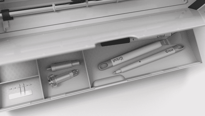The new and improved storage drawer of the Cricut Maker holding accessories and blades