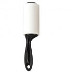 A sticky lint roller with black handle.
