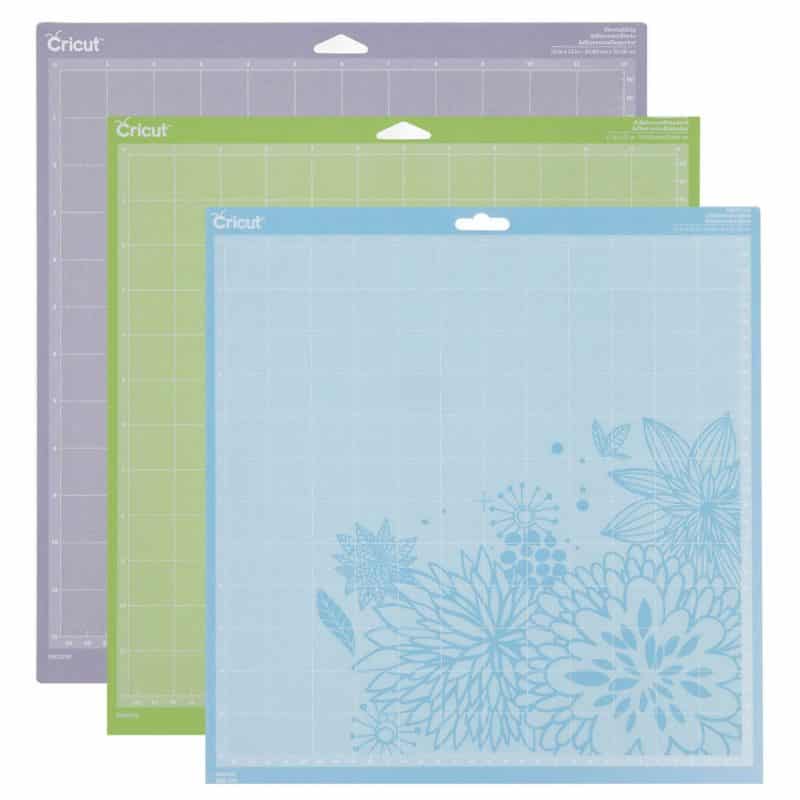 Three Cricut cutting mats: blue, green, and purple