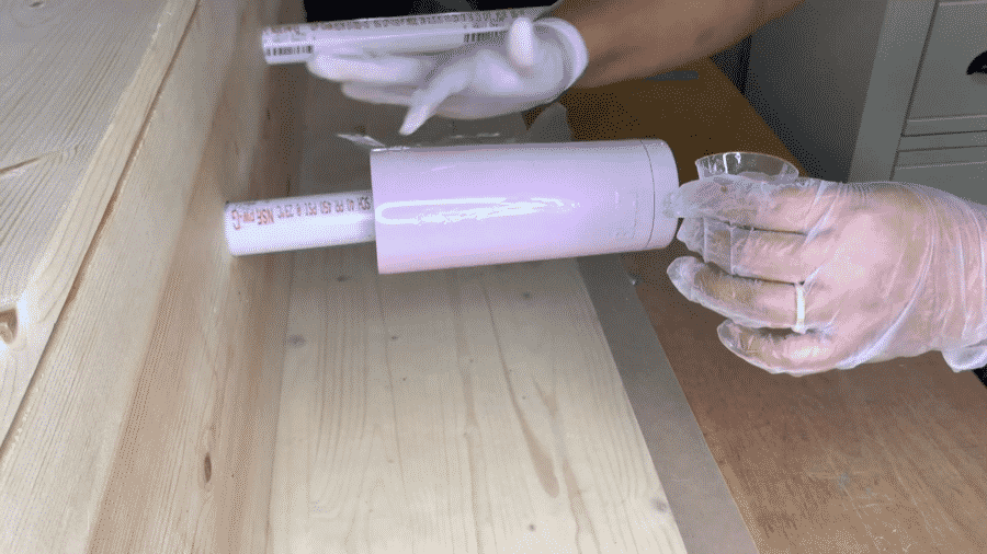 Applying the epoxy to the tumbler with a gloved finger