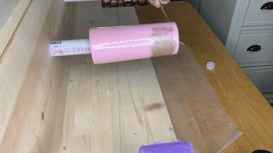 Applying additional glitter to the tumbler