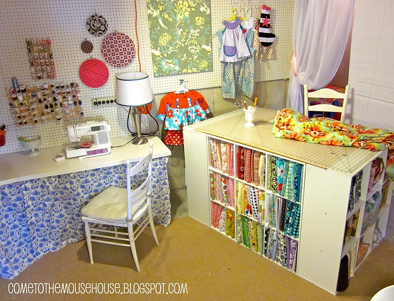 Basement sewing studio filled with fabrics and crafting tools