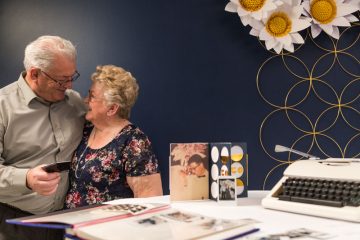 A happy couple celebrates their 50th anniversary with giant paper daisies.