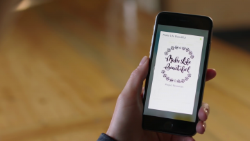 A woman uses Cricut Design Space on her phone, selecting a graphic that reads, "Make Life Beautiful."