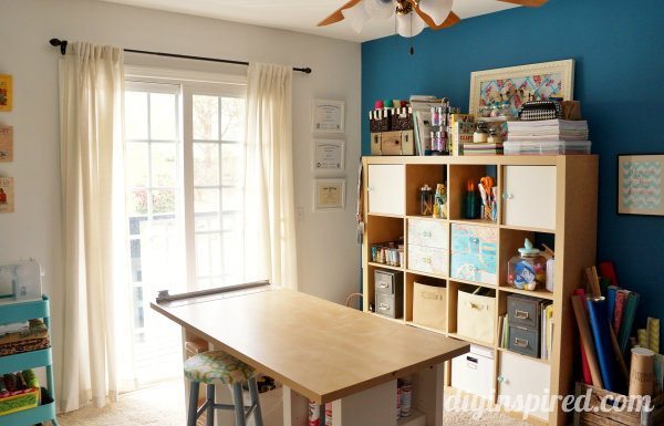 Cubbies under the table and up against a dark teal wall