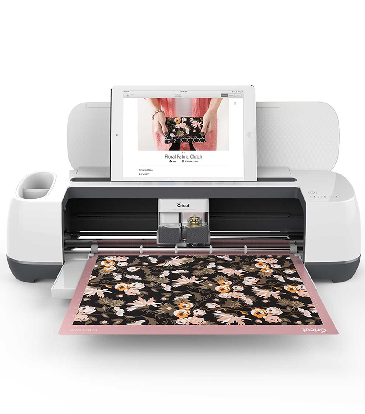 The Cricut Maker cuts out a beautiful floral pattern, with an iPad sitting comfortably on top.