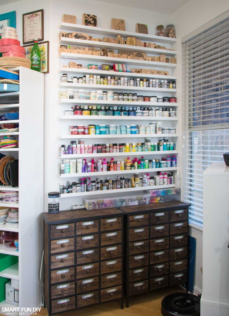 Rainbow wall of paints and inks sits on top of card catalogs