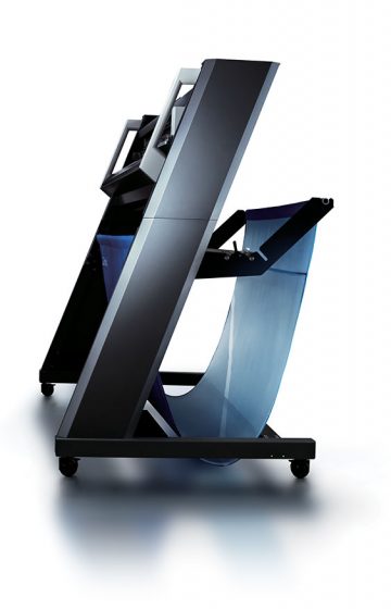 A gorgeous side view of a high end professional plotter with stand and catch basket.