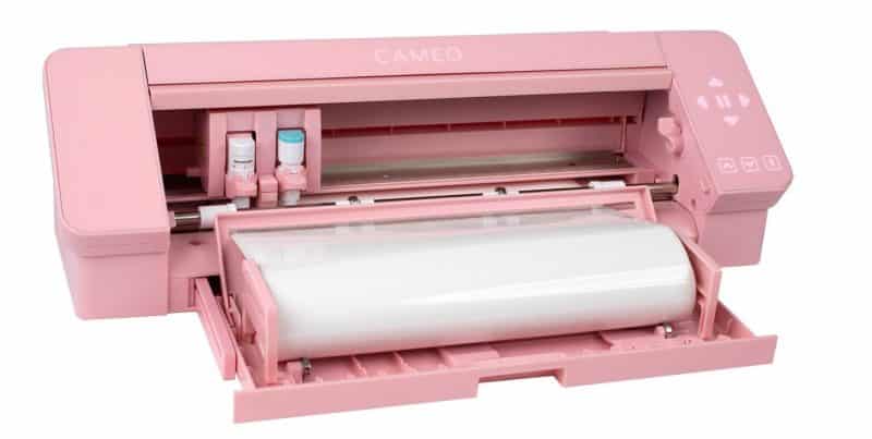 A pink Silhouette Cameo 4 with roll-feeder being used